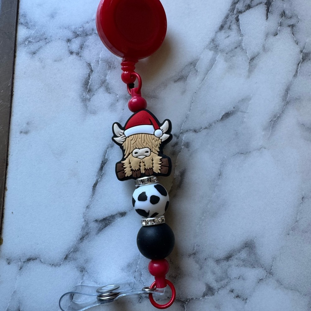 Cute Highland Cow Badge Reel with Santa Hat